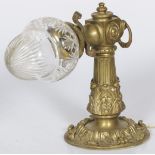 A brass wall lamp with cut glass shade, ca. 1900.