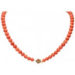 Single strand red coral necklace with a 14K. yellow gold closure with an Asian character.