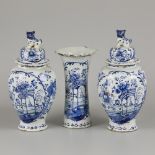 An earthenware garniture set decorated with floral motifs, Delft, 18th century.