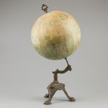 An "E Girard & A. Boitte, Paris" terrestial globe on cast metal stand with lions heads and claw feet
