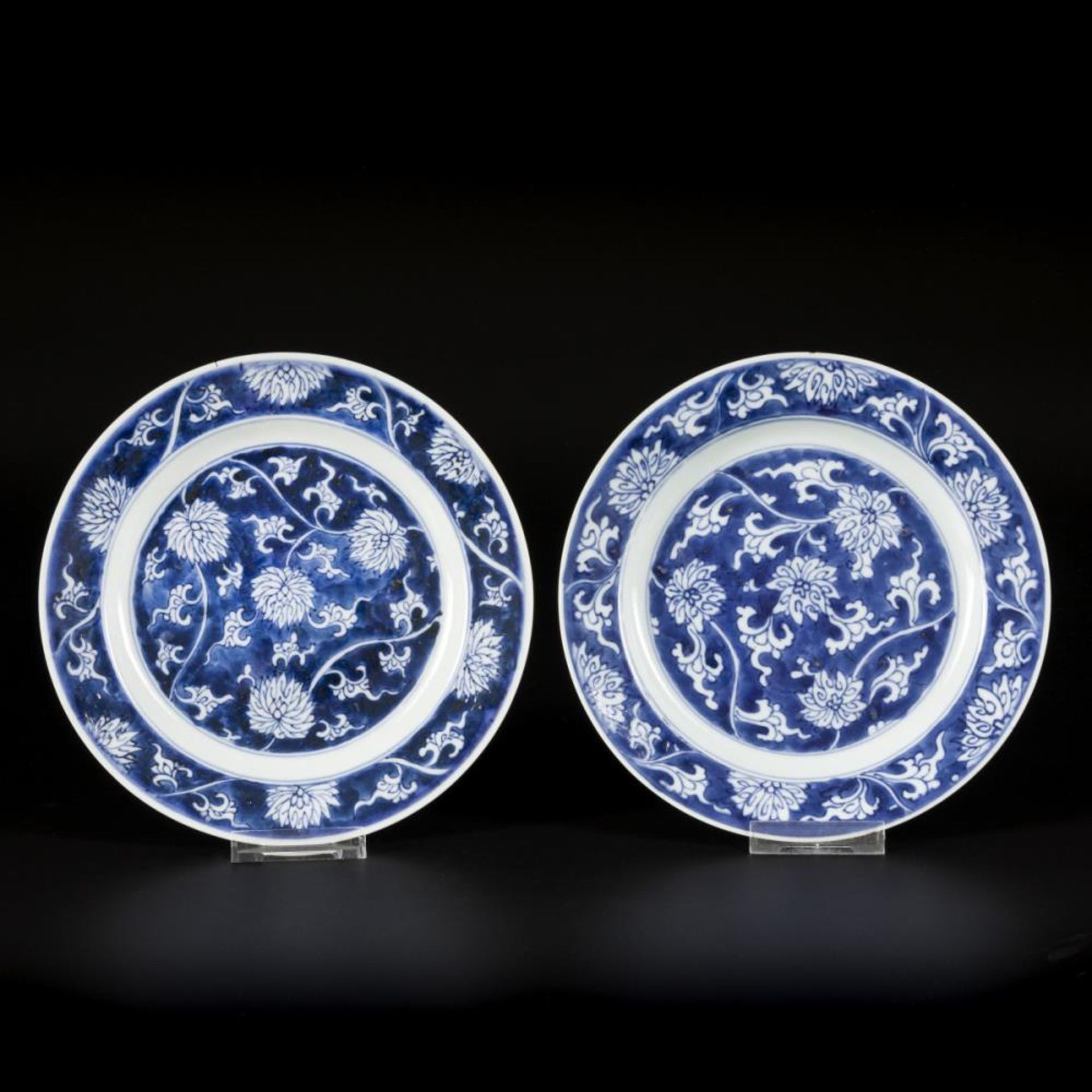 A set of (2) porcelain plates with lotus decoration in reversed technique, marked with incense burne