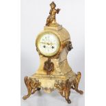 A 19th century matle clock mounted on brass feet and Psyche figurine.