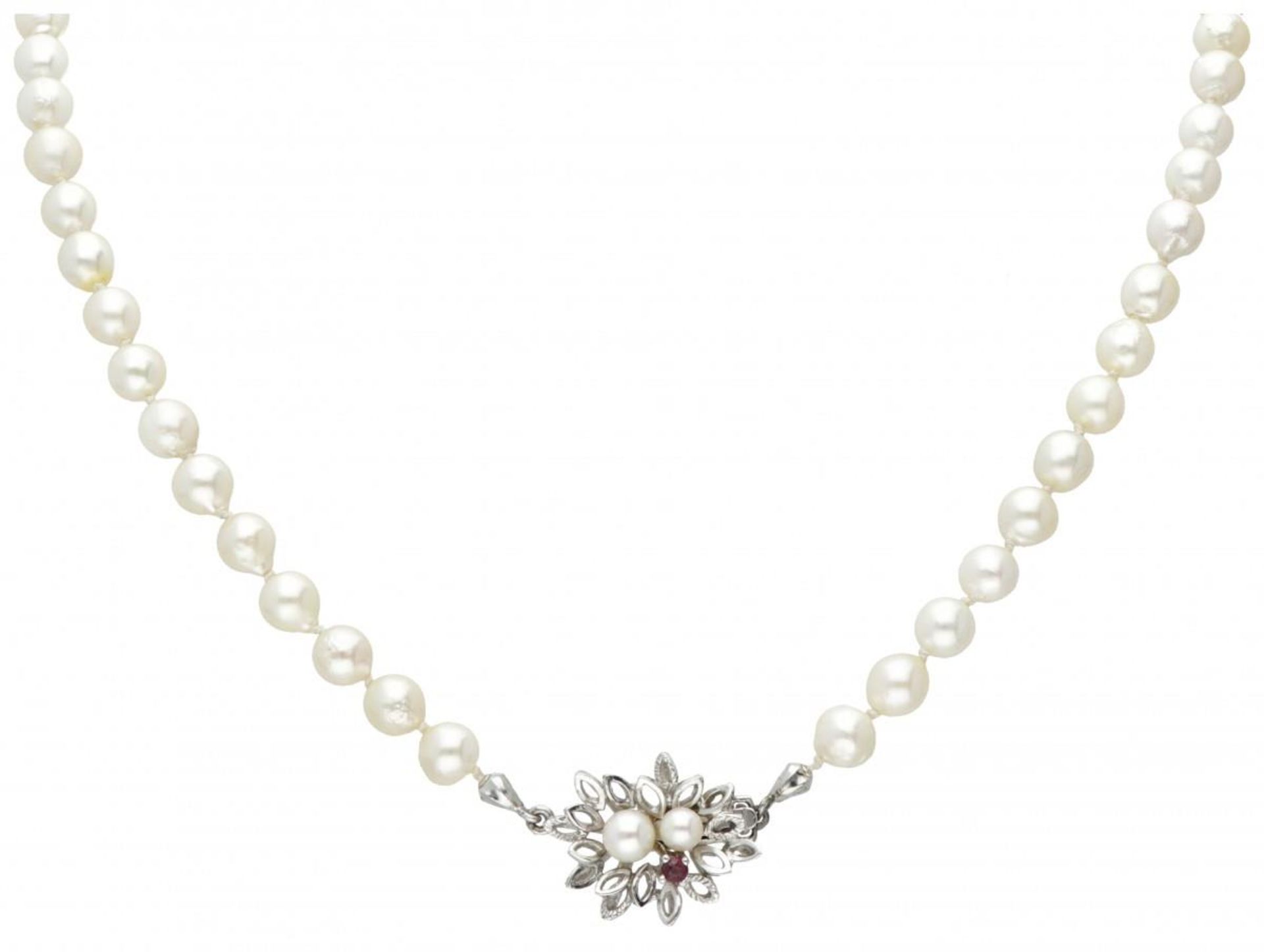 Single strand pearl necklace with a 14K. white gold closure set with pearl and ruby.