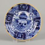 An earthenware peacock plate, marked "Bloempot", Delft, 18th century.
