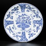 A porcelain charger with ribbed model with floral design, handle basket in the centre, China, Kangxi