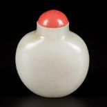 A celadon jade snuff bottle with blood coral cap, China, 19th century.