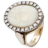 BLA 10K. Bicolor gold entourage ring set with approx. 5.07 ct. precious opal and approx. 0.48 ct. di