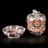 A lot comprised of a porcelain bowl and a lidded jar with Imari decoration, Japan, 19th century.