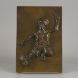 A bronze plaquette of a dancing Cossack.