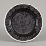 A black and grey enamelled charger depicting an equestrian couple, France, ca. 1900.