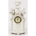 A French white biscuit overmantle clock with amor figurines under a Roman vase.