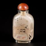 A glass snuff bottle decorated with goldfish and treasures.