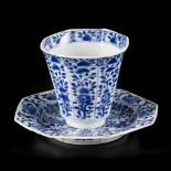 A porcelain angled 8-sided cup and saucer with floral decor, China, Kangxi.