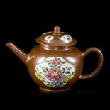 A porcelain famille rose teapot with lid, capucine exterior, China, 18th century.
