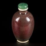 A porcelain sang de boeuf snuff bottle, China, 19th century.
