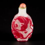 A glass snuff bottle decorated with red dragons, China, 19th century.