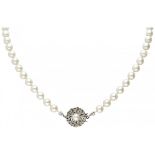 Single strand pearl necklace with a 14K. white gold closure set with cultured pearl and sapphire.