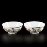 A set of (2) porcelain bowls with decoration of pupils in a garden, marked Qianglong, China, 20th ce