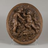 An oak carving of putti harvesting grapes (autumn), Belgium, 19th century.