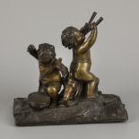 A bronze group with putti playing instruments.