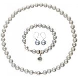 Set of pearl necklace, bracelet and earrings with 14K. white gold closures and pendant.