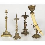 A lot of various bronze candlesticks and a horn with bronze fittings, 19th century and later.