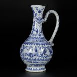 A porcelain blue-white pouring jug with floral decorations and landscape decors in the medallions, C