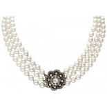 Three-row freshwater pearl necklace with a 14K. yellow gold/silver flower-shaped closure set with di