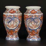 A set of (2) porcelain vases with Imari decoration, marked underneath, Japan, 19th century.