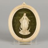 An ivory medallion with carved relief of a Madonna, Germany, 19th century.
