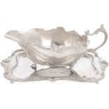 Sauce boat with silver dish.