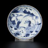 A porcelain plate decorated with figures in a landscape, China, 18th century.