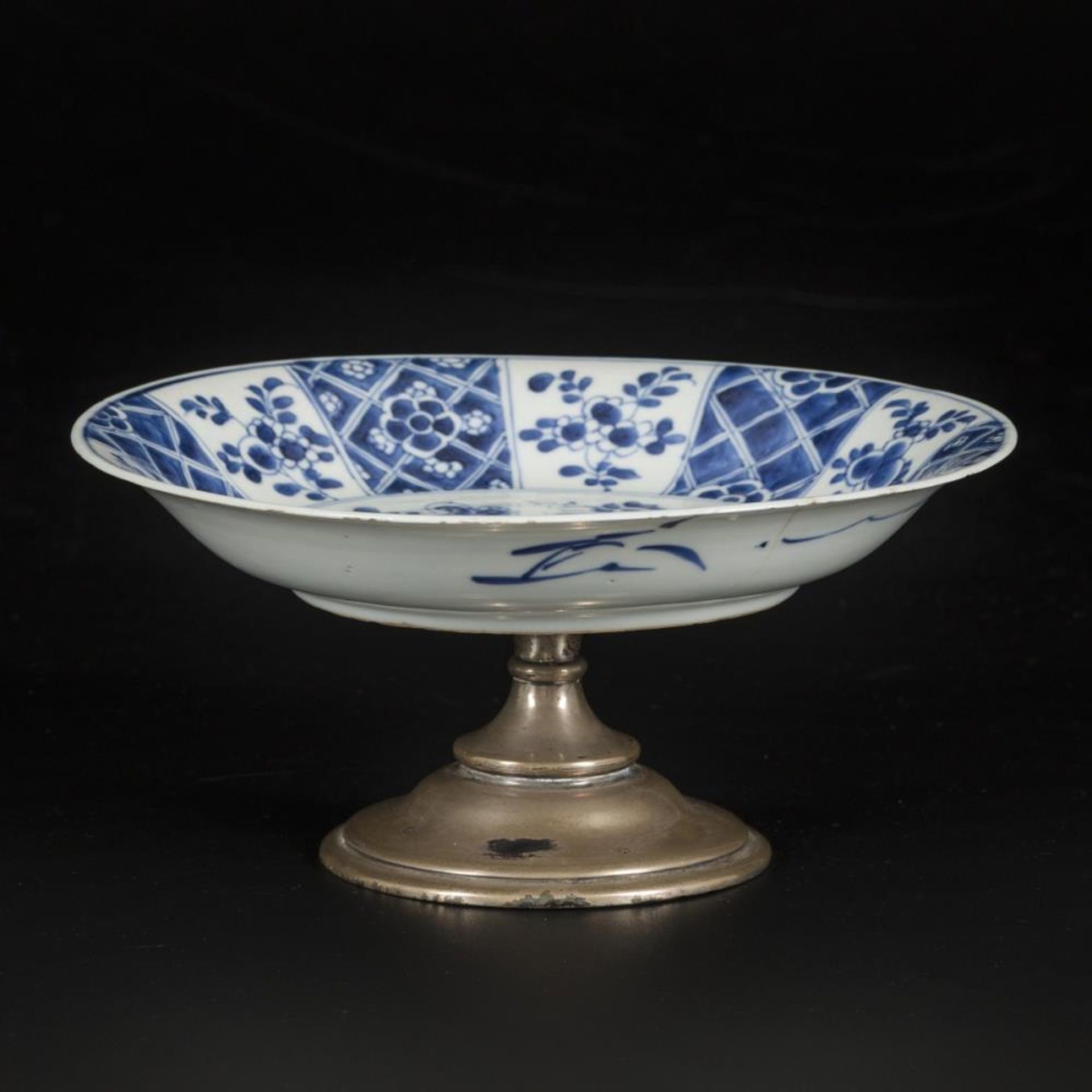 A porcelain plate on a silver base, China, Kangxi.