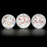 A lot comprising (3) porcelain famille rose plates with decorations of roosters and a deer, China, Y