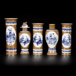 A porcelain garniture set with café-au-lait fond and decorated with Chinese figures, marked Kangxi,