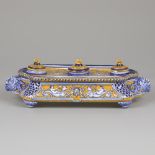 A majolica inkstand decorated with putti seated on sea monsters and various lion mascarons, Italy, c