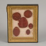 A set of (6) various laquer wax seals in Empire-style frame, France, 19th century.