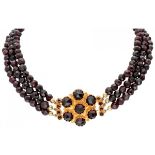 Three-row vintage garnet necklace with a 14K. yellow gold closure set with garnet.