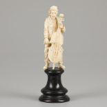 An ivory sculpture of a man with bass, 19th century.