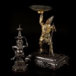 A lot comprising (2) bronze candlesticks of which one on wooden base, 19th/20th century.
