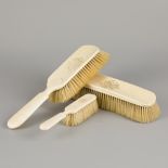 An ivory vanity set comprising (3) various brushes, ca. 1900 / 1920.