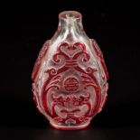 A glass snuff bottle decorated with red dragons, China, 19th century.