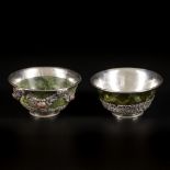 A set of (2) 'spinach jade' bowls with silver mounts, Tibet, ca. 1900.