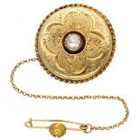 14K. Yellow gold antique elegantly engraved brooch set with one diamond.
