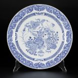 A porcelain charger with decoration of antiques and flowers, China, Yongzheng/Qianlong.