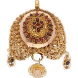 Antique 14K. yellow gold filigree costume pendant set with garnet and Zeeland knots.