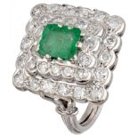 BLA 10K. White gold entourage ring set with approx. 0.96 ct. diamond and emerald.