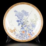 A porcelain charger decorated with a bird on a branch, Japan, 19th century.