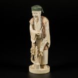 An ivory statuette of a scholar, Japan, late Meiji period.