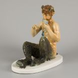 A polychromed porcelain statuette of a pan-flute playing faun, Germany, 2nd half 20th century.
